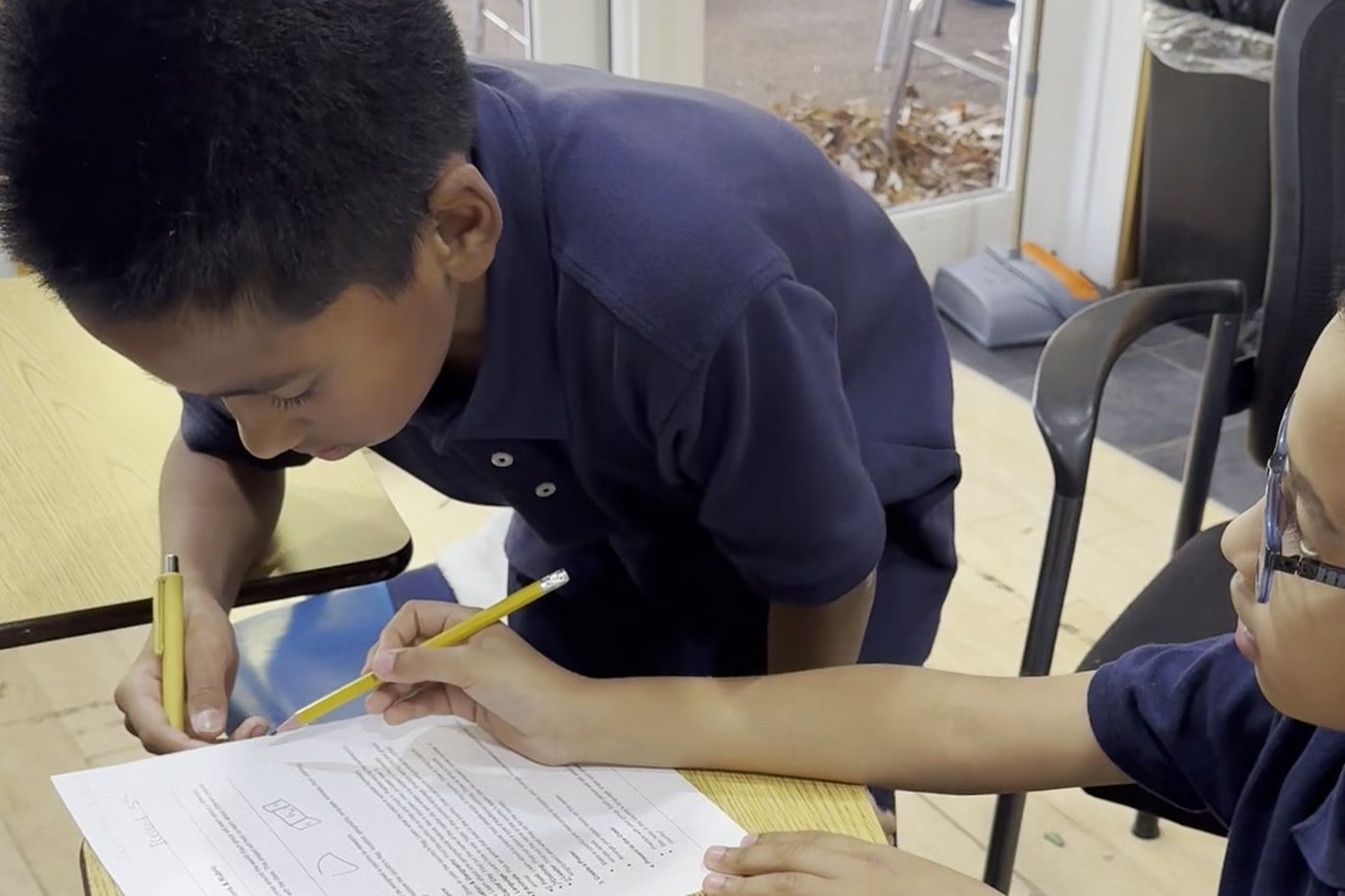 Two Oceans Academy students working through a worksheet together in class
