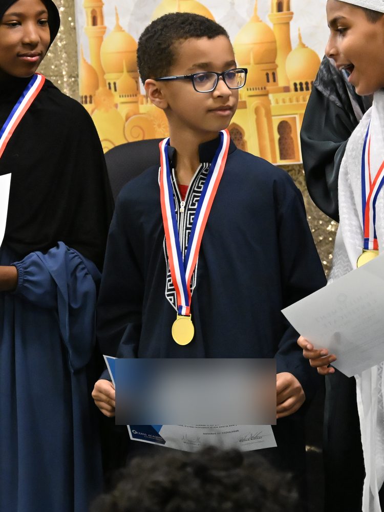 An Oceans Academy student wearing his first place medal