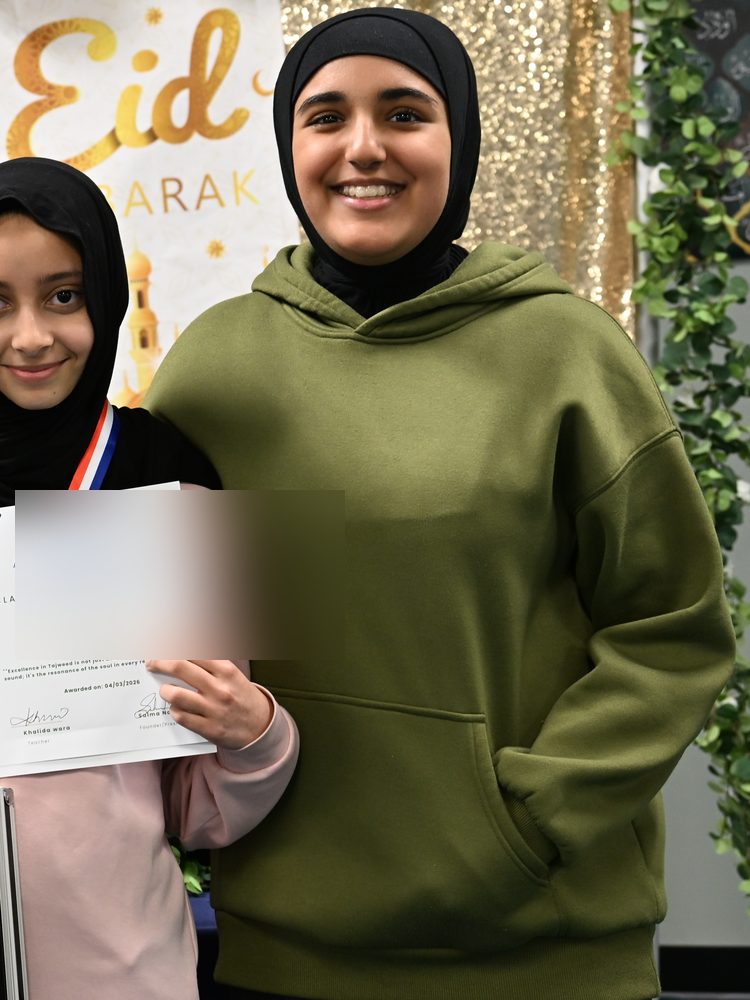 An Oceans Academy student holding her achievement certificate